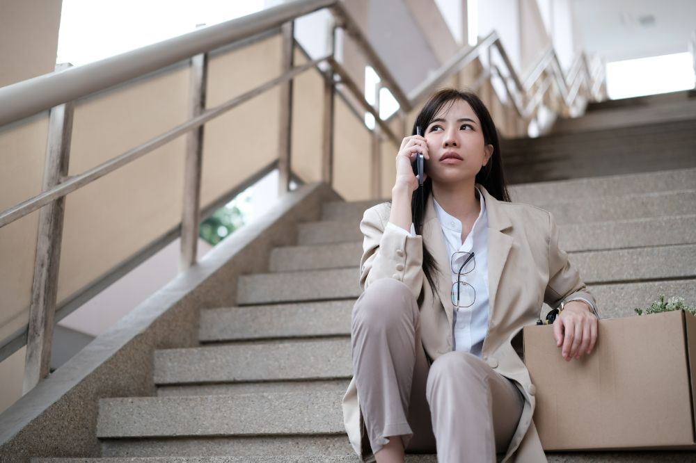 Business woman on the phone looking stressed and about to leave